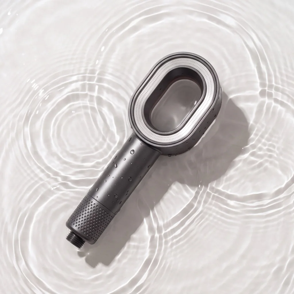 Generated graphite shower head photographed against rippling water and light.