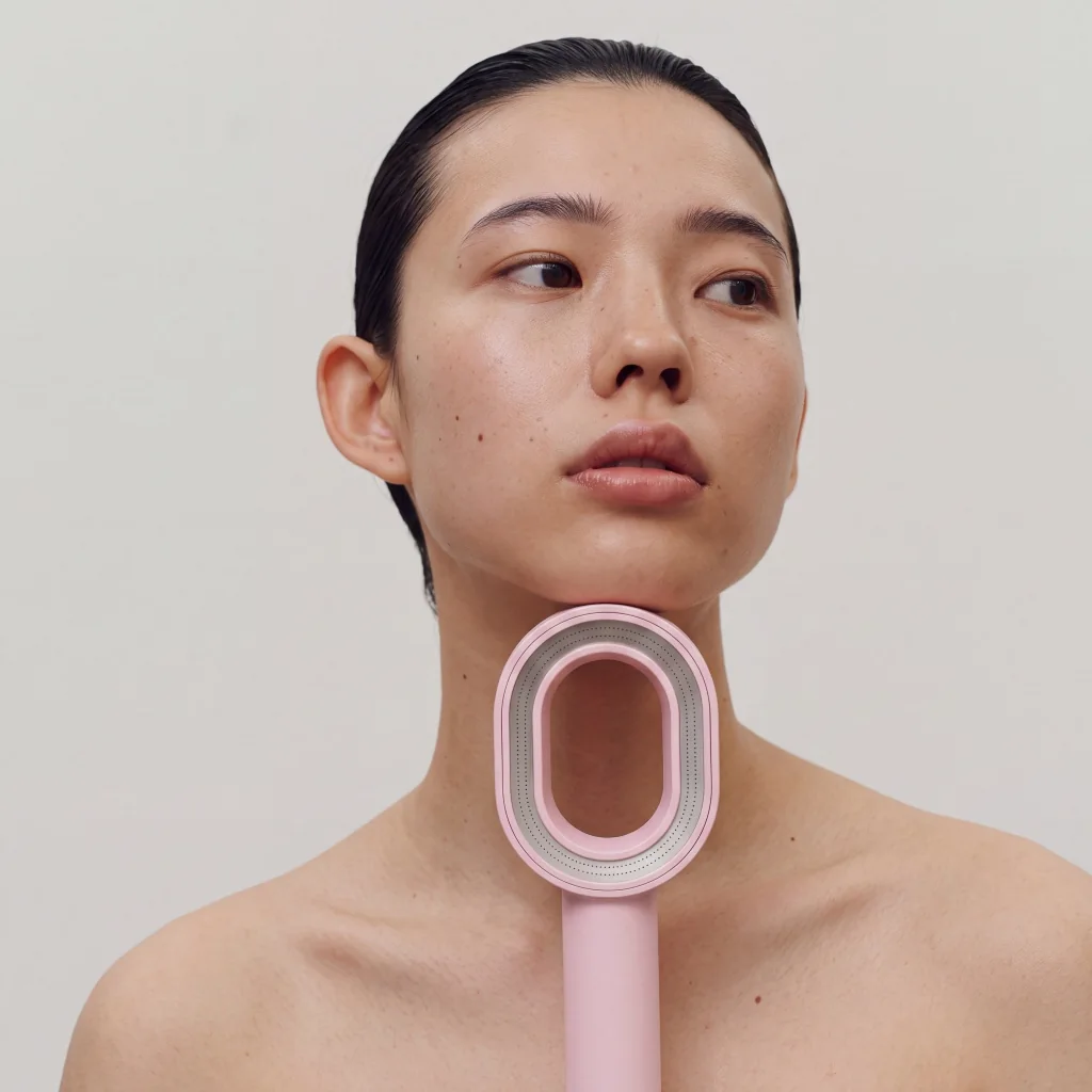 Generated campaign image of a model holding a pink filtered shower head below her face.