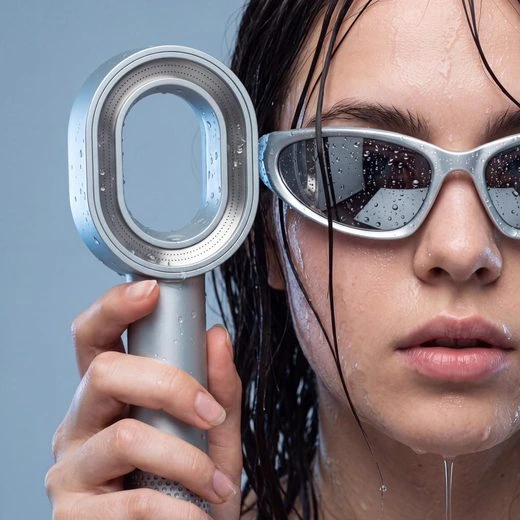 Generated editorial product image showing a model holding the silver shower head.